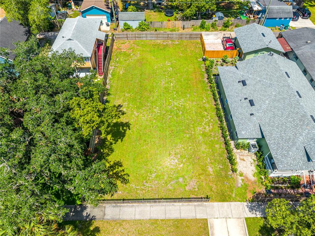 An aerial view shows a vacant rectangular residential lot situated between two existing houses — 1010 ELM AVENUE, SANFORD, FL
