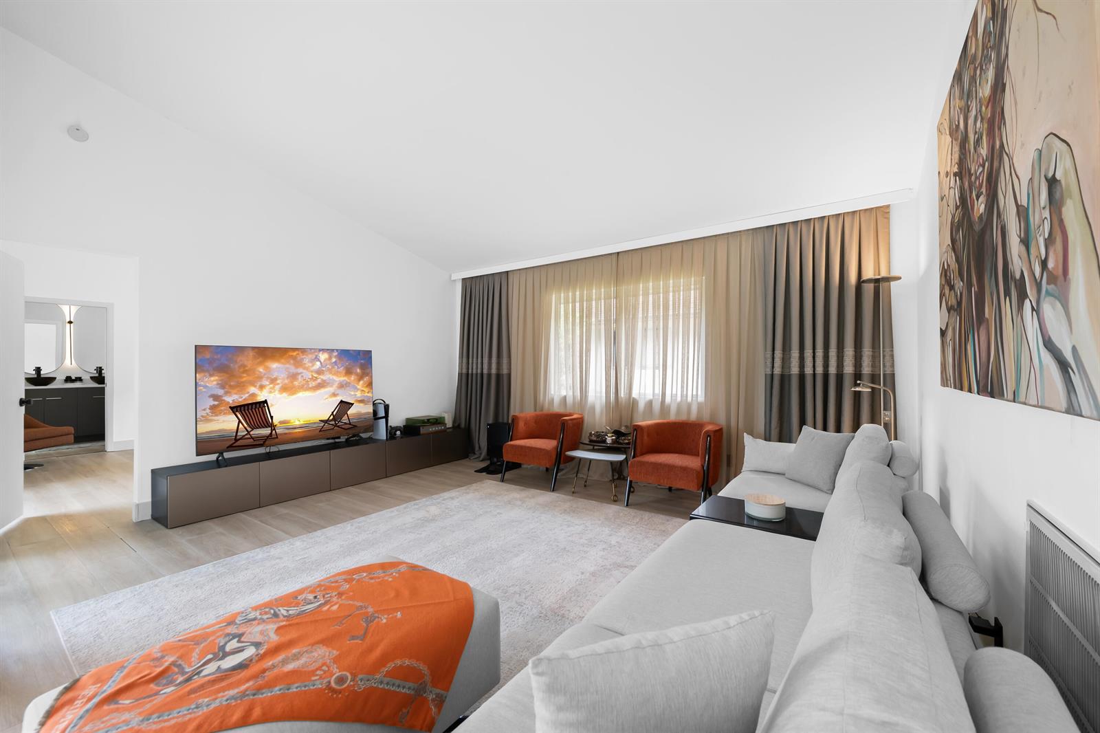 A living room features a large gray sectional sofa, two orange armchairs, and a television — 22448 Swordfish Drive, Boca Raton FL 33428, BOCA RATON, FL