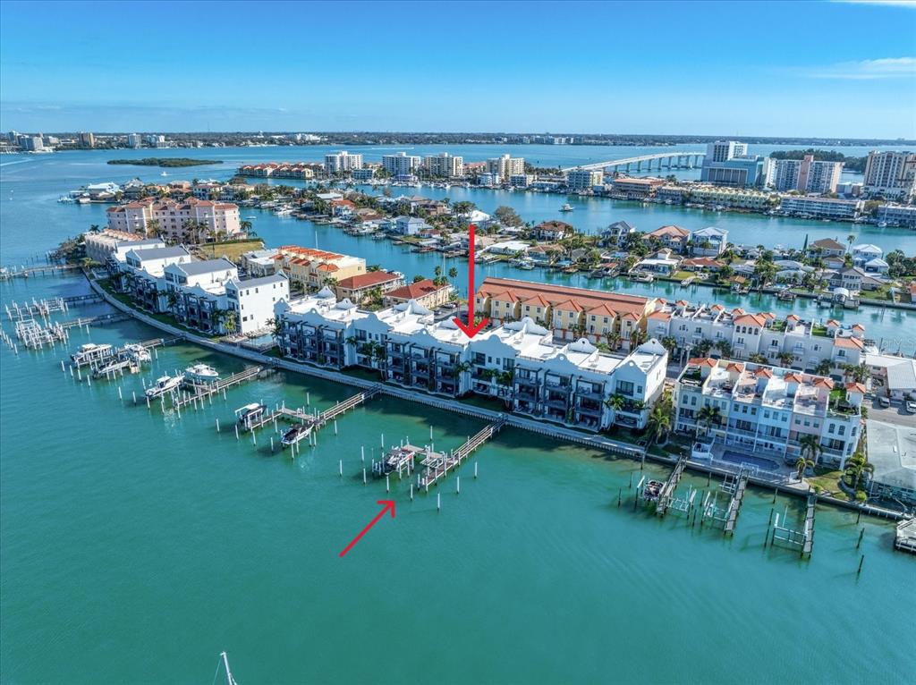 An aerial view of a waterfront condominium complex with private boat docks on the bay — 158 BRIGHTWATER DRIVE UNIT 2, CLEARWATER BEACH, FL