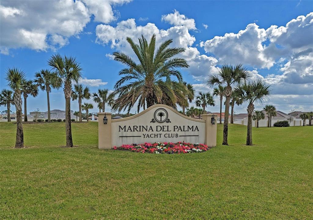 A sign for the Marina Del Palma Yacht Club stands in a grassy field — 92 DEL PALMA DRIVE, PALM COAST, FL