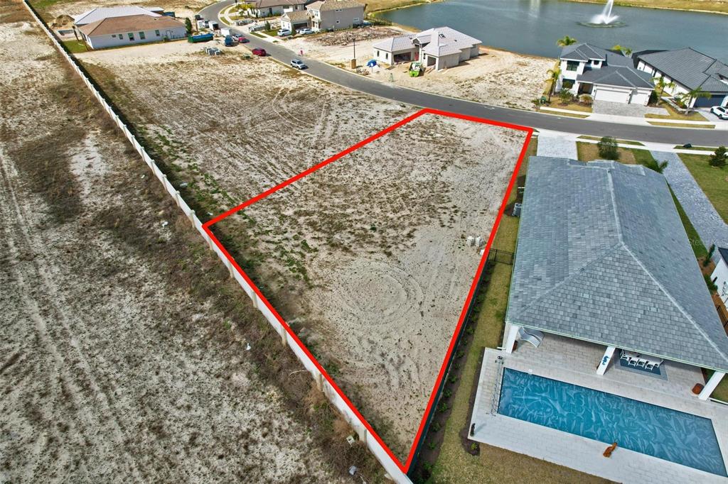 An aerial view shows a vacant, rectangular residential lot outlined in red next to a house — 92 DEL PALMA DRIVE, PALM COAST, FL