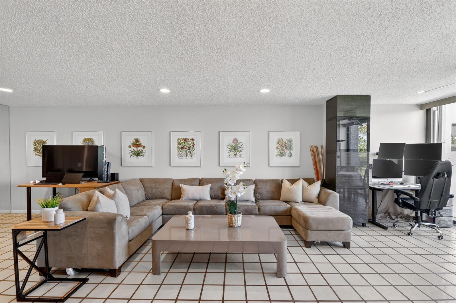A living room features a large brown sectional sofa, a coffee table, and two desk areas — 4272 Deste Court # 101, Lake Worth FL 33467, LAKE WORTH, FL