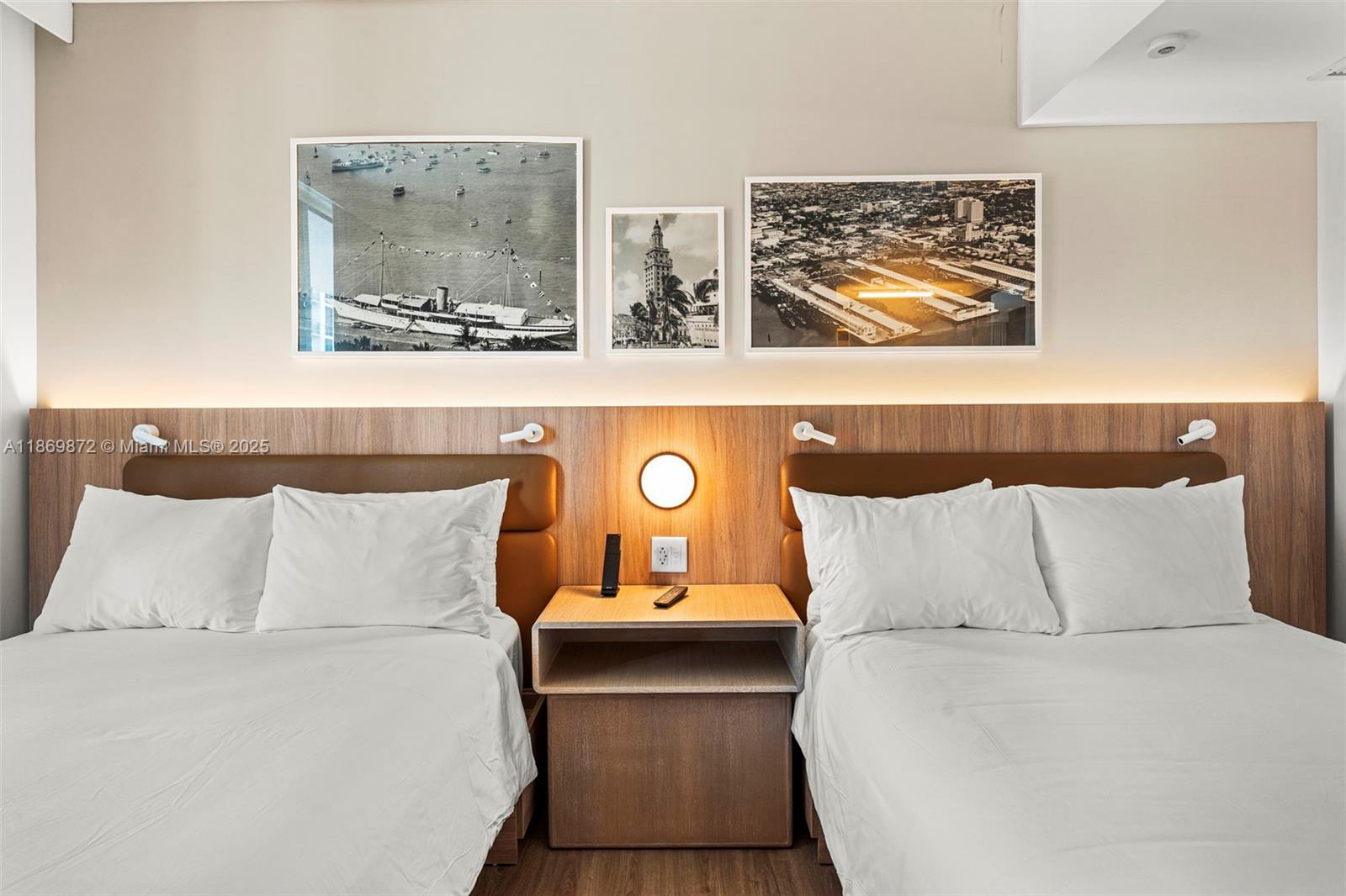 A hotel room features two beds separated by a nightstand with a wall-mounted light — 601 NE 1st Ave # 1803, Miami FL 33132, MIAMI, FL
