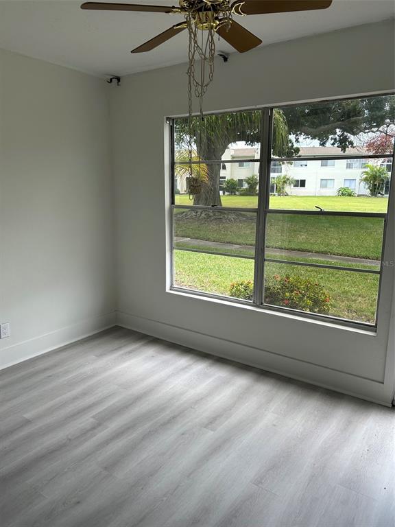 An exterior view shows a white door labeled 132 next to a brick wall — 4520 OVERLOOK DRIVE NE UNIT 132, ST PETERSBURG, FL