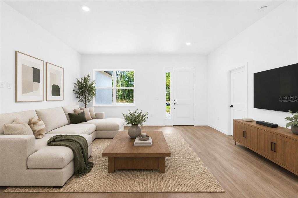 A newly constructed single-story house with a gray garage door and a paved driveway — 1318 W DUPONT DRIVE, DUNNELLON, FL