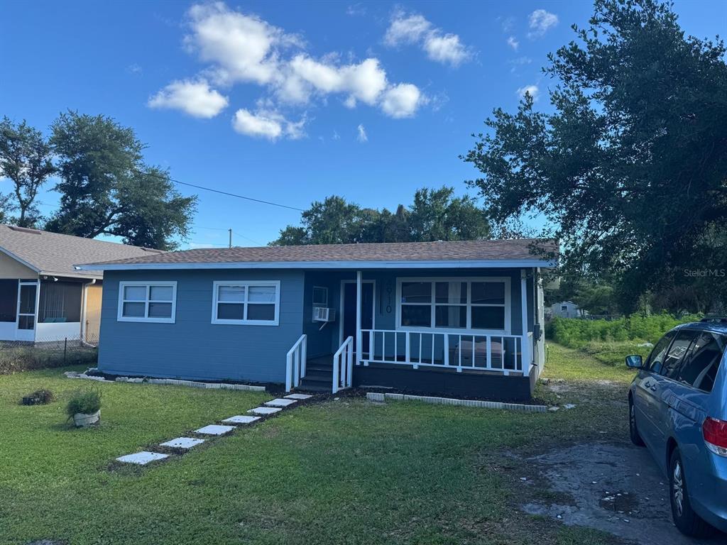 A blue single-story house with a front porch and a white railing — 4910 HUPPEL AVENUE, ORLANDO, FL