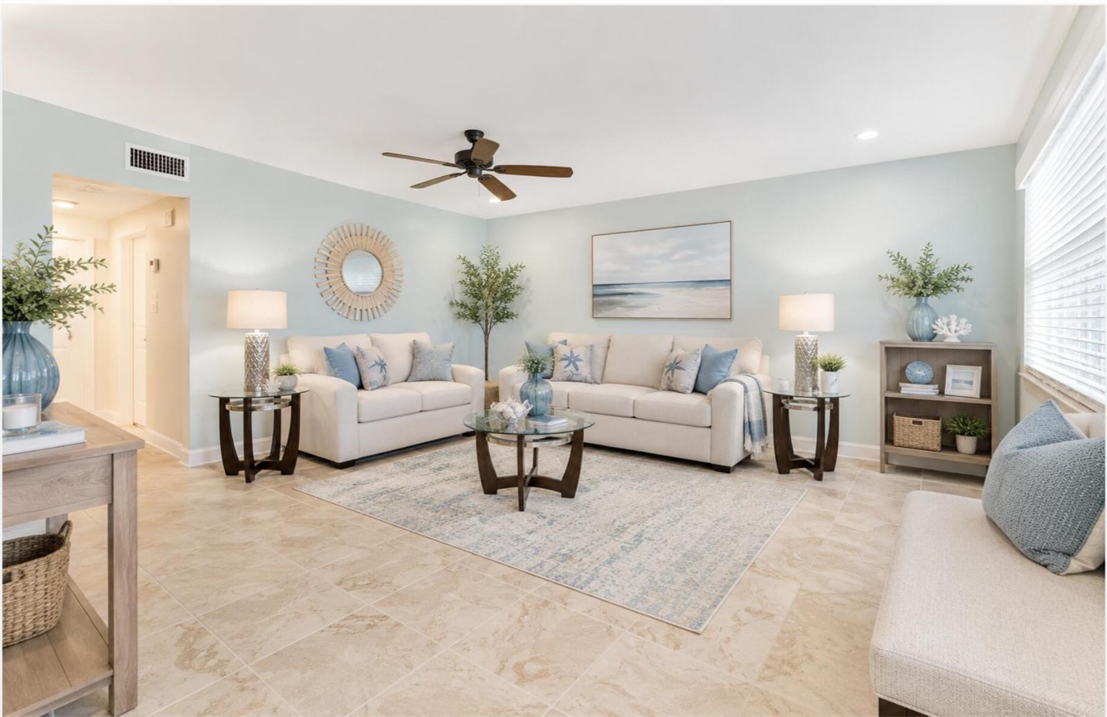 A living room features light blue walls, beige sofas, a glass coffee table, and tile flooring — 201 Valencia I, Delray Beach FL 33446, DELRAY BEACH, FL