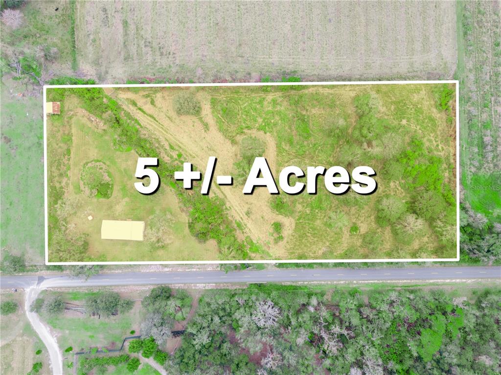 An aerial view shows a rectangular plot of land with trees and a small building — 5926 VAN SIMMONS ROAD, WAUCHULA, FL