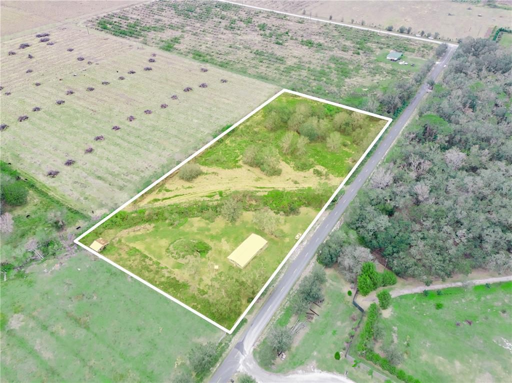 An aerial view shows a rectangular plot of land with a building and trees — 5926 VAN SIMMONS ROAD, WAUCHULA, FL