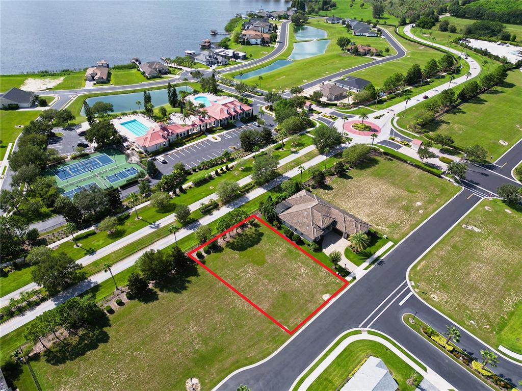 An aerial view shows a vacant residential lot outlined in red next to a house — 247 BLAZING STAR AVENUE, LAKE ALFRED, FL