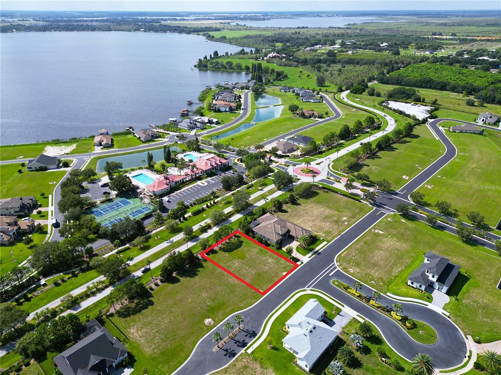 An aerial view shows a vacant residential lot outlined in red within a suburban neighborhood — 247 BLAZING STAR AVENUE, LAKE ALFRED, FL