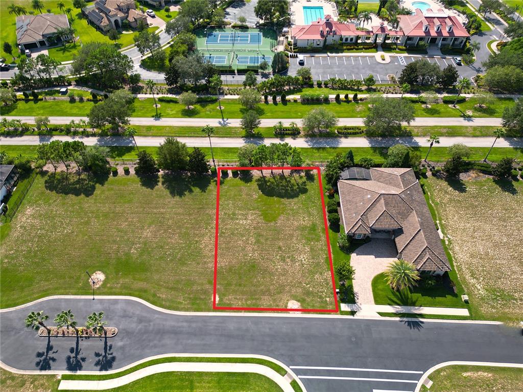 An aerial view shows a vacant residential lot outlined in red next to a house — 247 BLAZING STAR AVENUE, LAKE ALFRED, FL