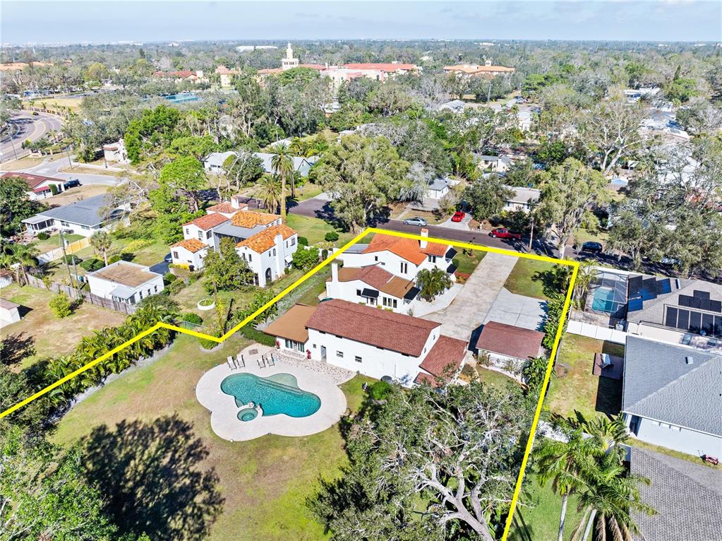 An aerial view shows a house with a pool and large backyard outlined in yellow — 6010 17TH AVENUE S, GULFPORT, FL