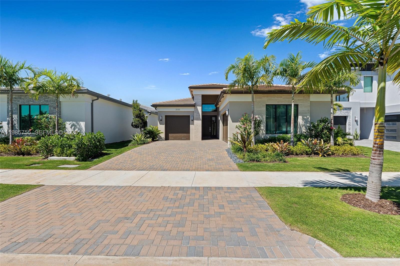 A single-story house with a paved driveway, palm trees, and a landscaped front yard — 21135 Tangelo Tree Dr, Boca Raton FL 33434, BOCA RATON, FL