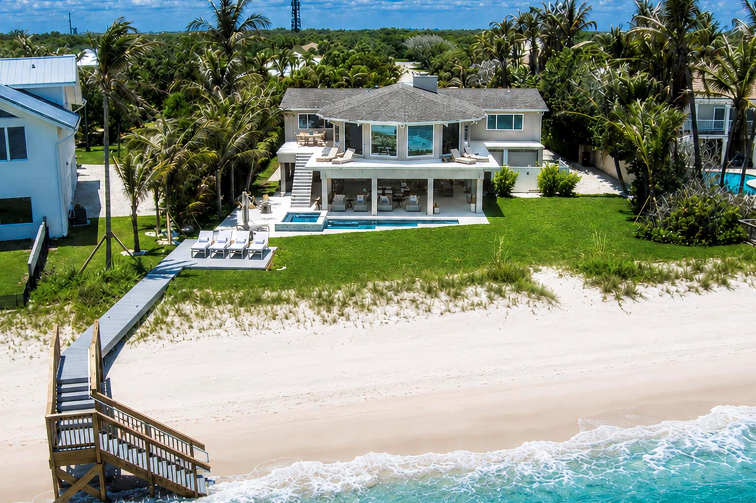 An aerial view of a beachfront house with a pool, deck, and private beach access — VERO BEACH, FL
