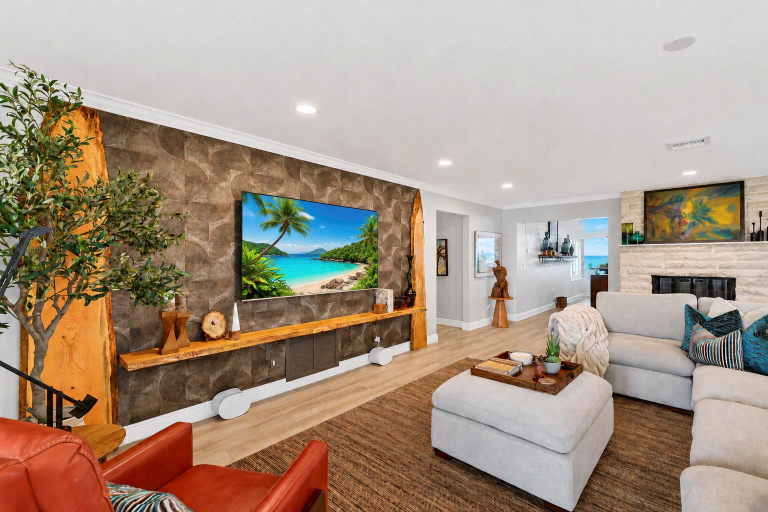 A living room features a textured accent wall with a mounted television and wood shelving — VERO BEACH, FL