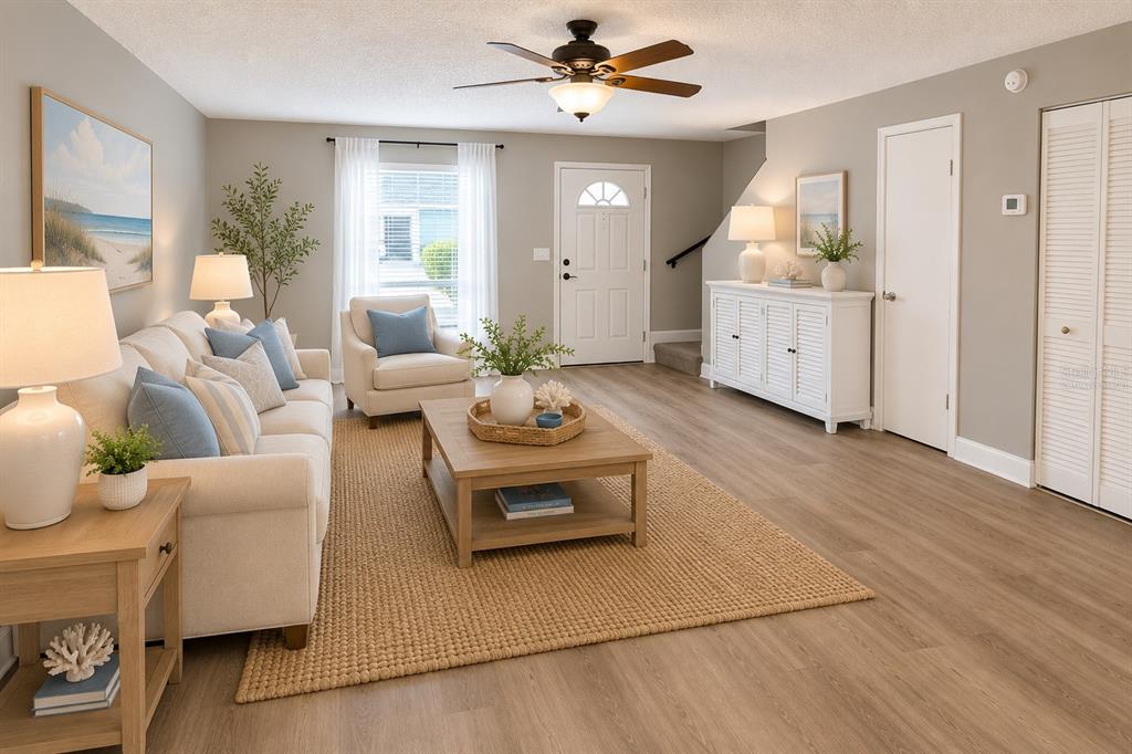 A living room features light wood floors, a beige sofa, and a white console table — 11905 CYPRESS VISTA, TAMPA, FL