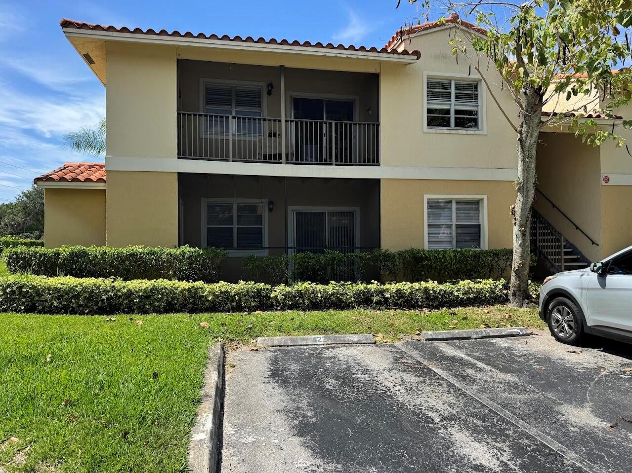 A two-story apartment building with balconies, stucco walls, and a parking space in front — 1227 SW 46th Avenue SW # 301, Pompano Beach FL 33069, POMPANO BEACH, FL
