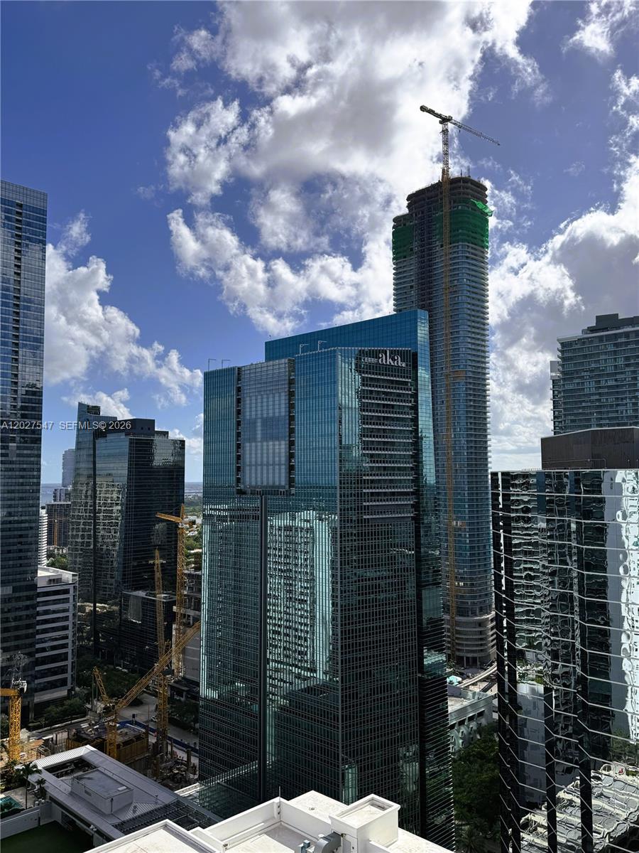 An exterior view of multiple modern glass skyscrapers in a dense urban city skyline — 1200 Brickell Bay Dr # 3903, Miami FL 33131, MIAMI, FL