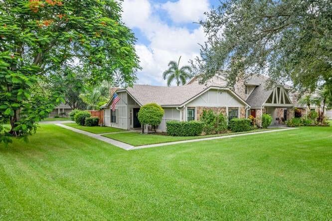 A single-story house with a stone facade and a lawn in a suburban neighborhood — 1960 Derby Trail, Wellington FL 33414, WELLINGTON, FL