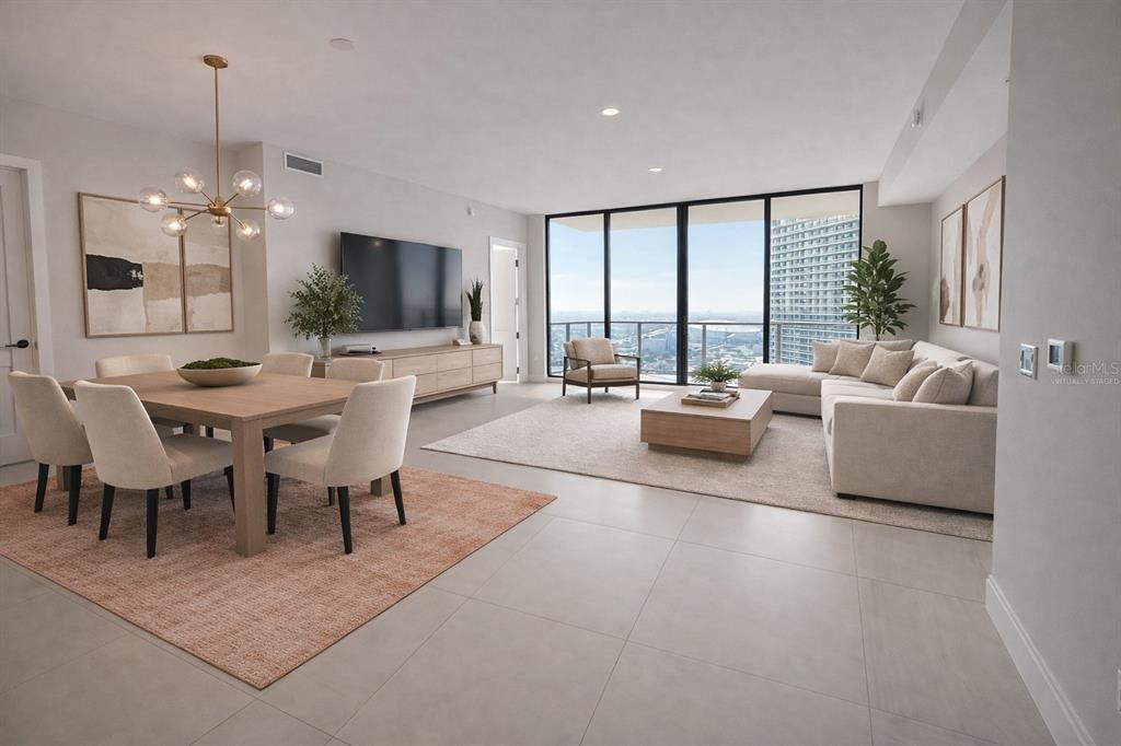 A modern, virtually staged open-concept living and dining room with floor-to-ceiling windows and city views — 275 1ST AVENUE UNIT 3807, ST PETERSBURG, FL