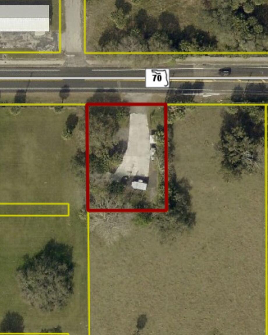 Aerial view of a rectangular property lot with a paved driveway along a highway — 2594 Hwy 70 W, Okeechobee FL 34974, OKEECHOBEE, FL