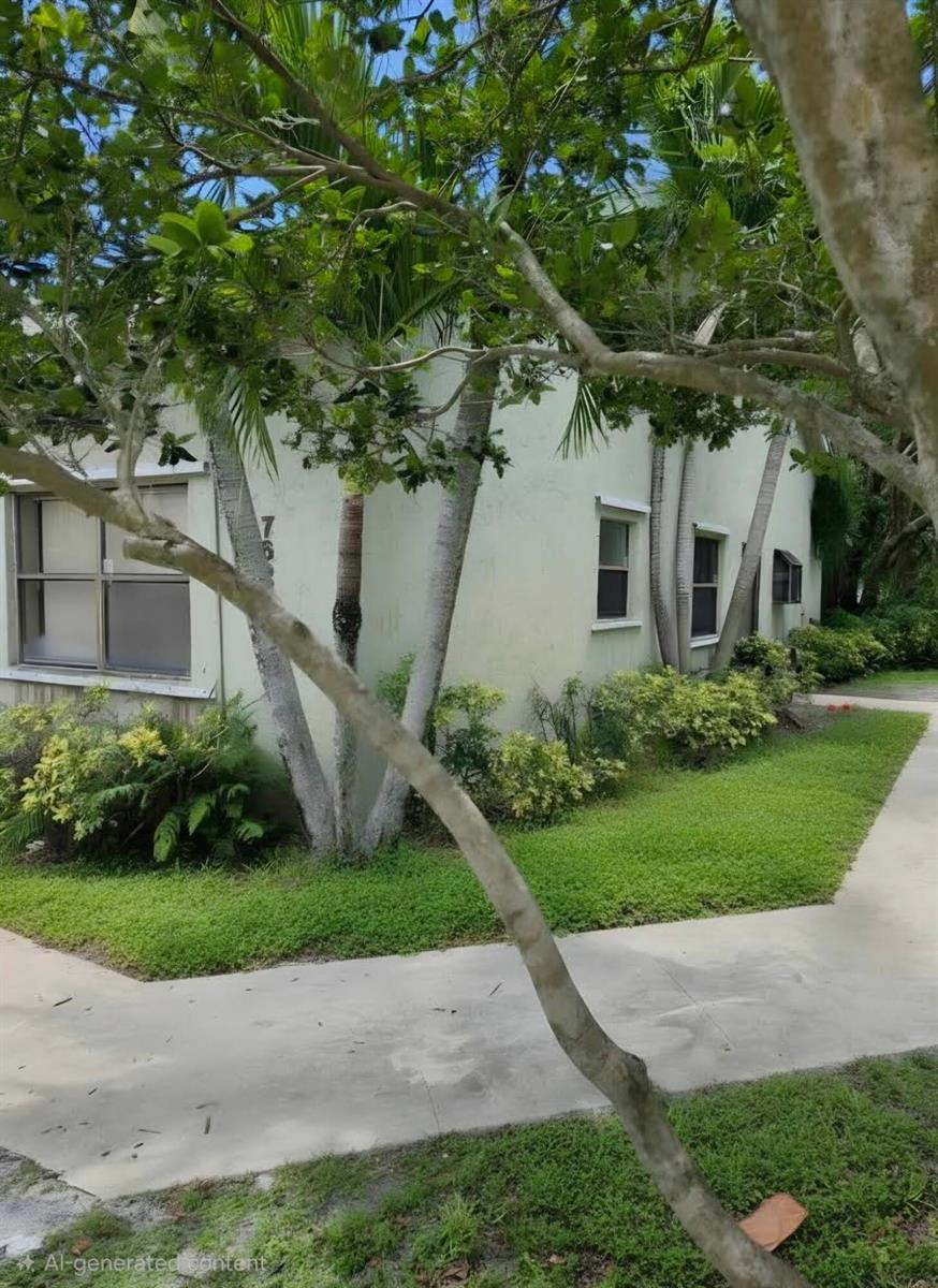 A light-colored building exterior with palm trees, landscaping, and a concrete walkway — 7620 NW 38th Court, Sunrise FL 33351, SUNRISE, FL