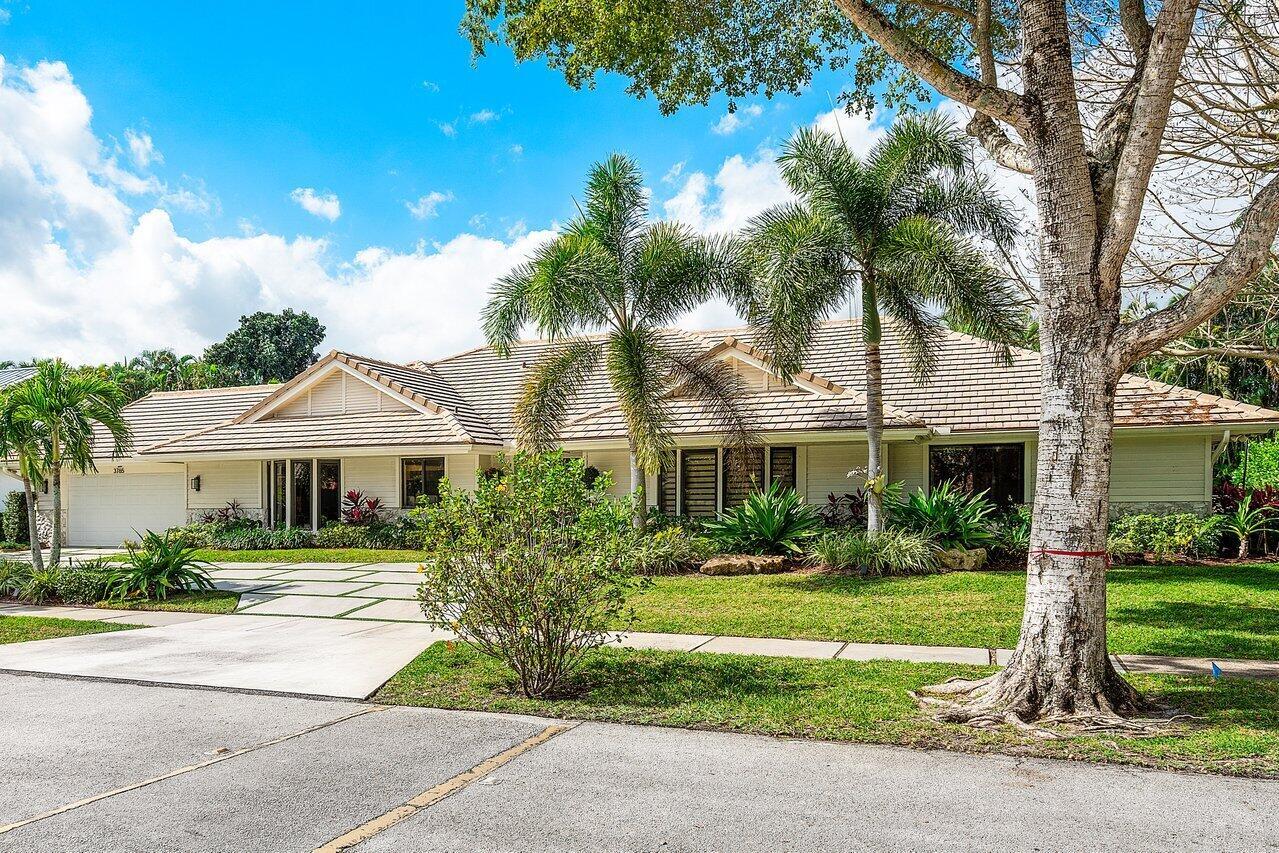 A single-story house with a beige exterior, a tiled roof, and palm trees in the yard — 3765 Kings Way, Boca Raton FL 33434, BOCA RATON, FL