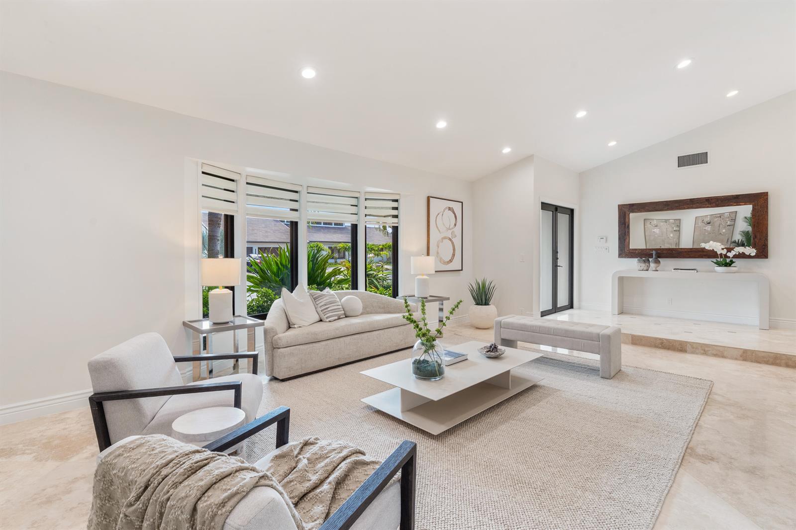 A bright living room features light-colored furniture, a tiered coffee table, and large windows — 3765 Kings Way, Boca Raton FL 33434, BOCA RATON, FL
