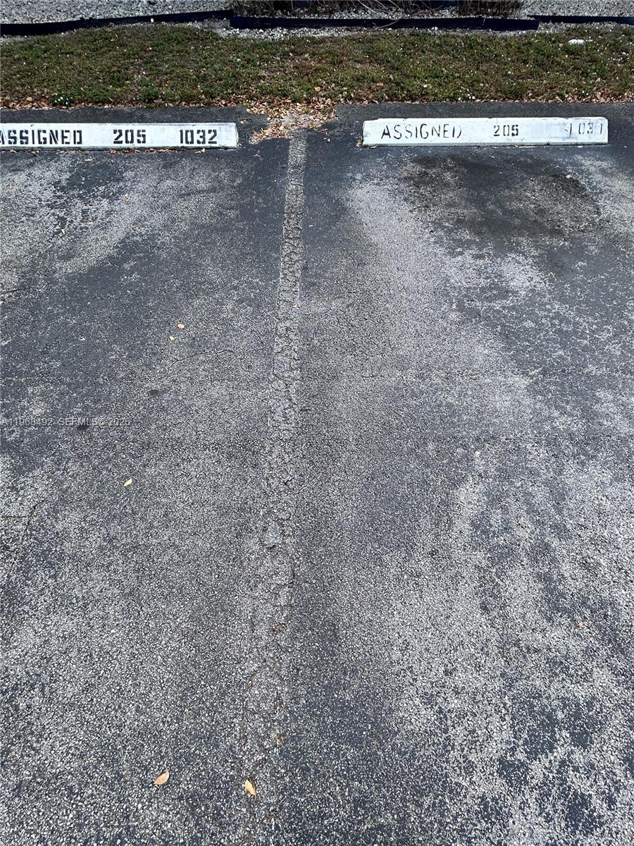 Two parking spaces are marked as assigned with the numbers 205 and 1032 — 7030 NW 179th St # 205, Hialeah FL 33015, HIALEAH, FL