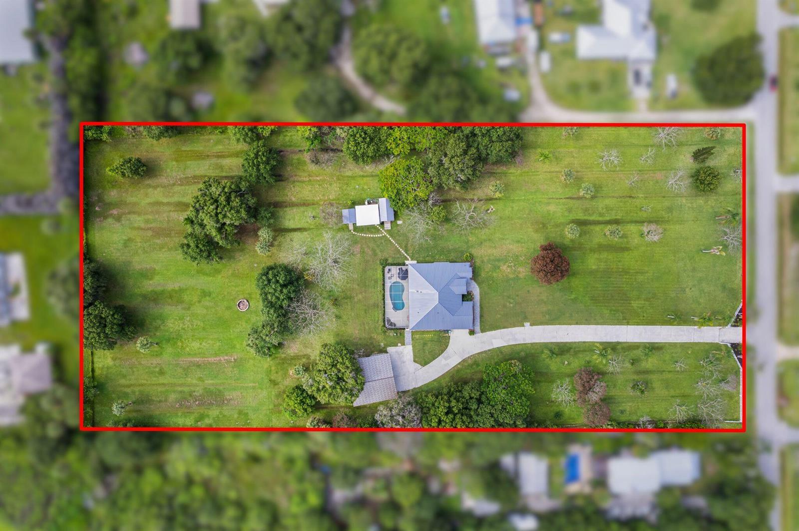 An aerial view shows a house with a pool and detached garage on a large lot — 4800 Christensen Road, Fort Pierce FL 34981, FORT PIERCE, FL