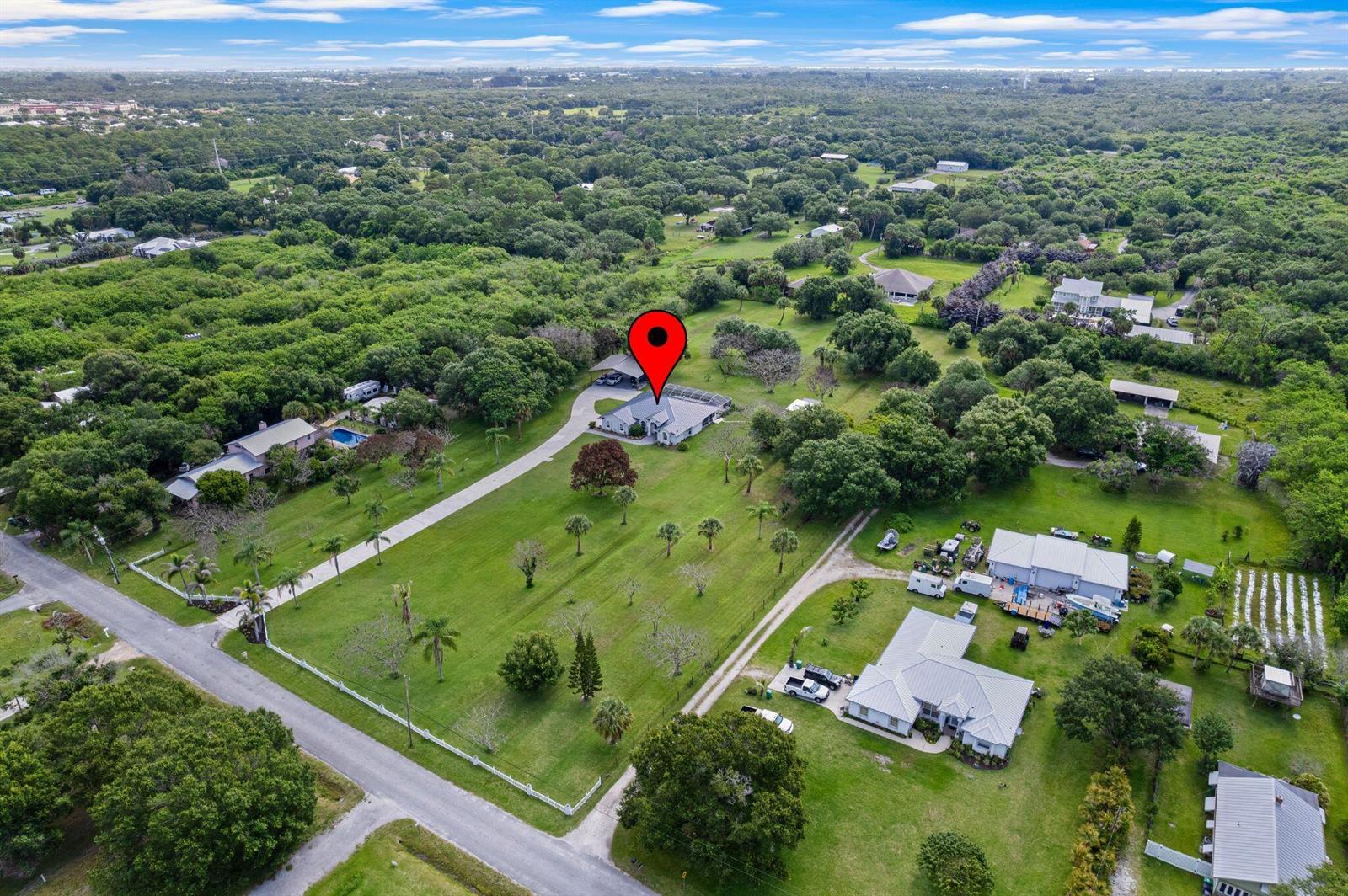 An aerial view shows a house with a red map pin on a large grassy lot — 4800 Christensen Road, Fort Pierce FL 34981, FORT PIERCE, FL