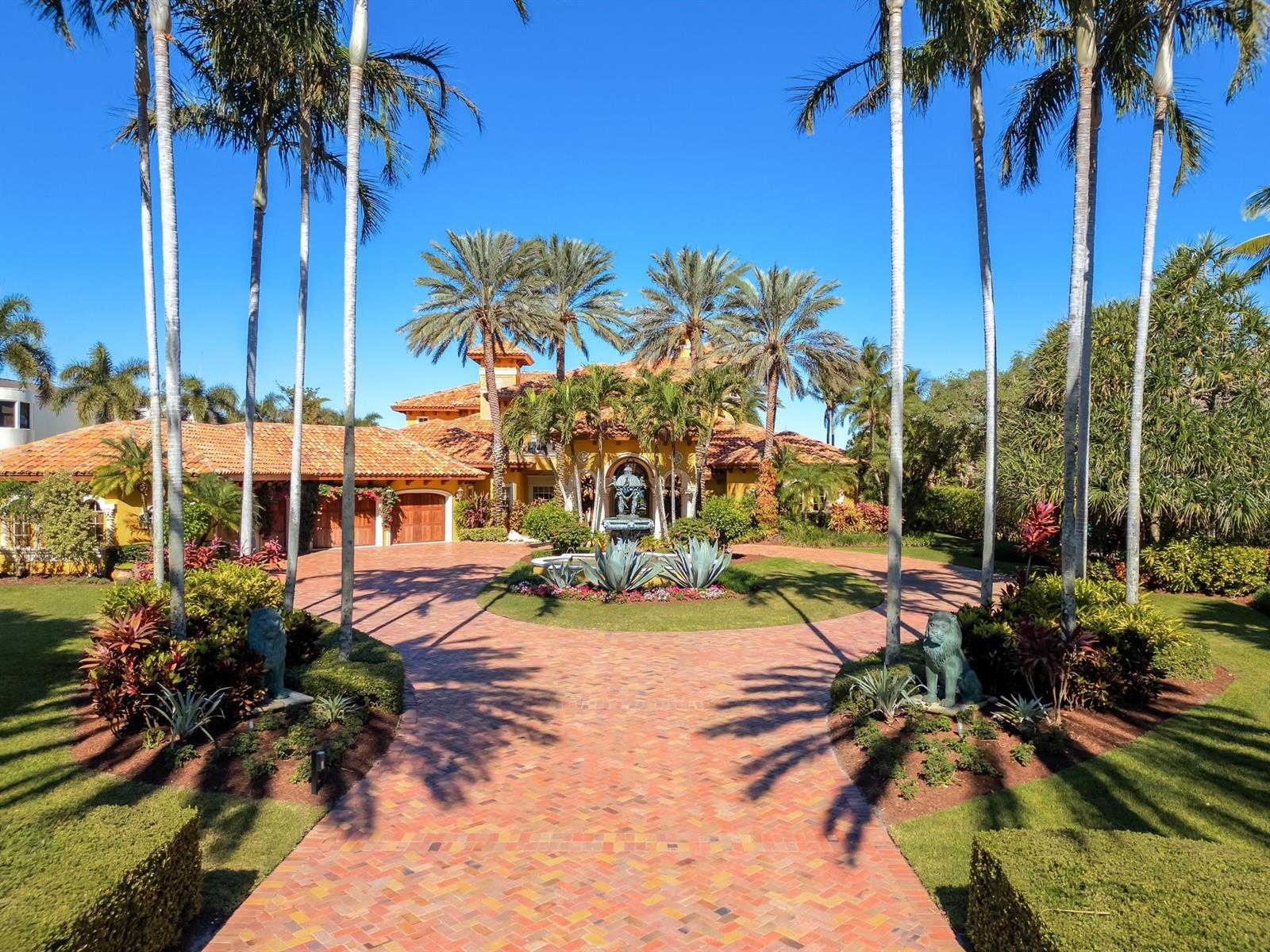 A Mediterranean-style house with a brick driveway, palm trees, and a central fountain — 4089 SE Old Saint Lucie Boulevard, Stuart FL 34996, STUART, FL