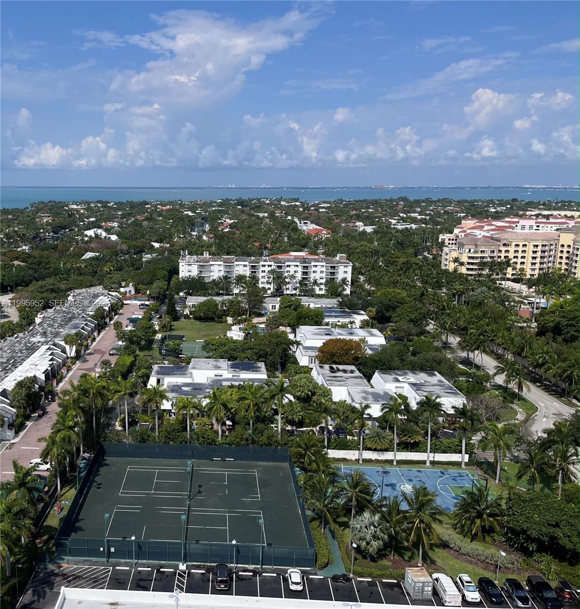 An elevated view shows a tennis court, a basketball court, and surrounding residential buildings — 881 Ocean Dr # 18B, Key Biscayne FL 33149, KEY BISCAYNE, FL