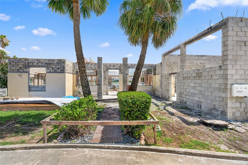 An exterior view of a house under construction with concrete block walls and palm trees — 246 BAYSIDE DRIVE, CLEARWATER BEACH, FL