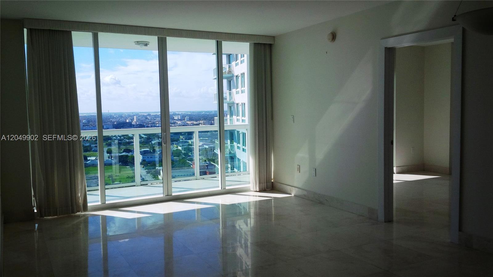 A bright living room features marble floors, floor-to-ceiling windows, and a balcony with city views — 1800 N Bayshore Dr # 3310, Miami FL 33132, MIAMI, FL