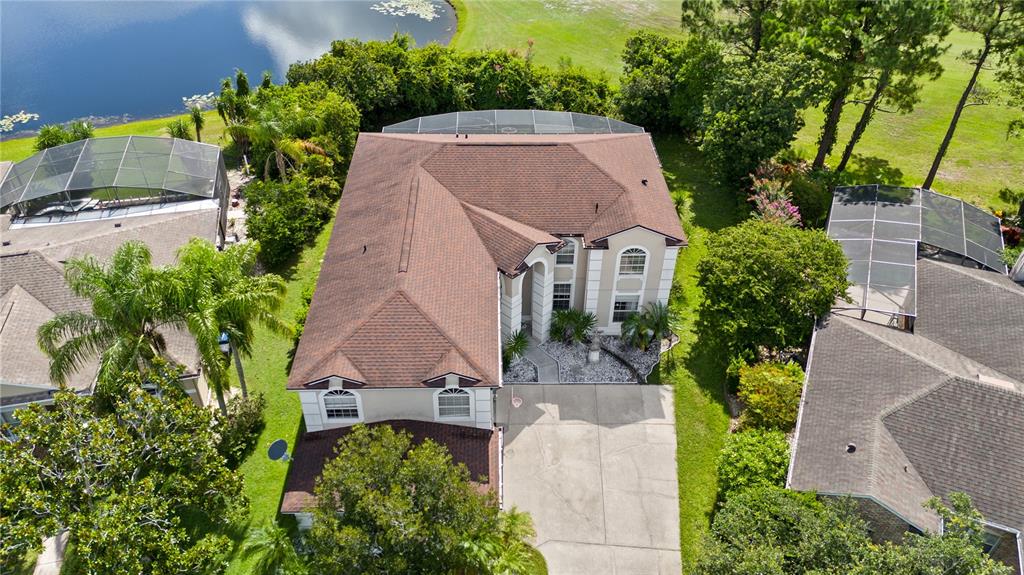 An aerial view shows a two-story house with a brown roof and a screened pool — 2072 STONE CROSS CIRCLE, ORLANDO, FL