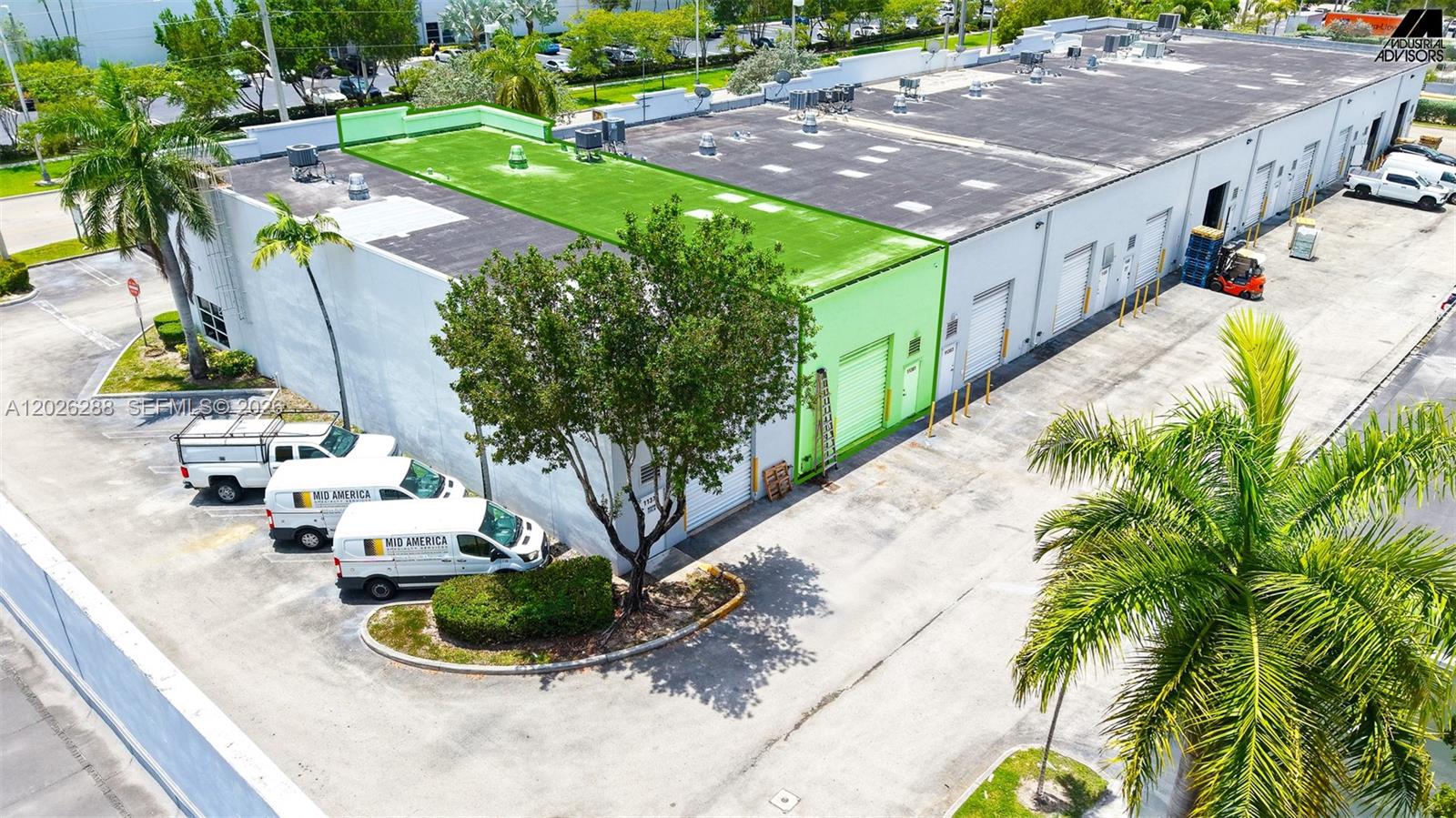 An aerial view shows a commercial warehouse building with a green-painted roof section — 11381 NW 122nd St # 10, Medley FL 33178, MEDLEY, FL