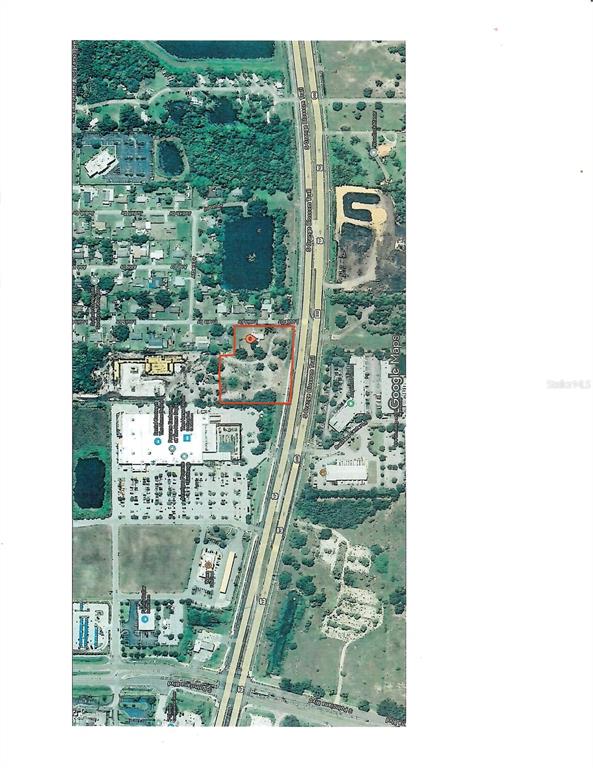 This is an aerial map showing a property outlined in red next to a highway — 1714 LOUIS DRIVE, KISSIMMEE, FL