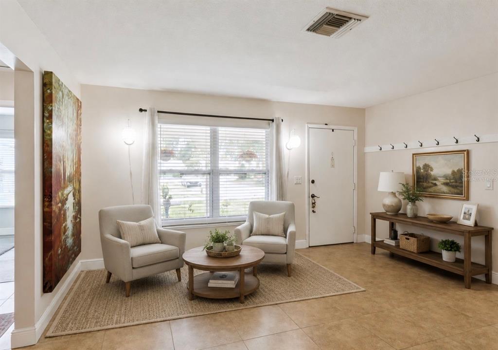 A living room features two armchairs, a round coffee table, and a console table — 5246 MAYAPPLE CIRCLE, ORLANDO, FL