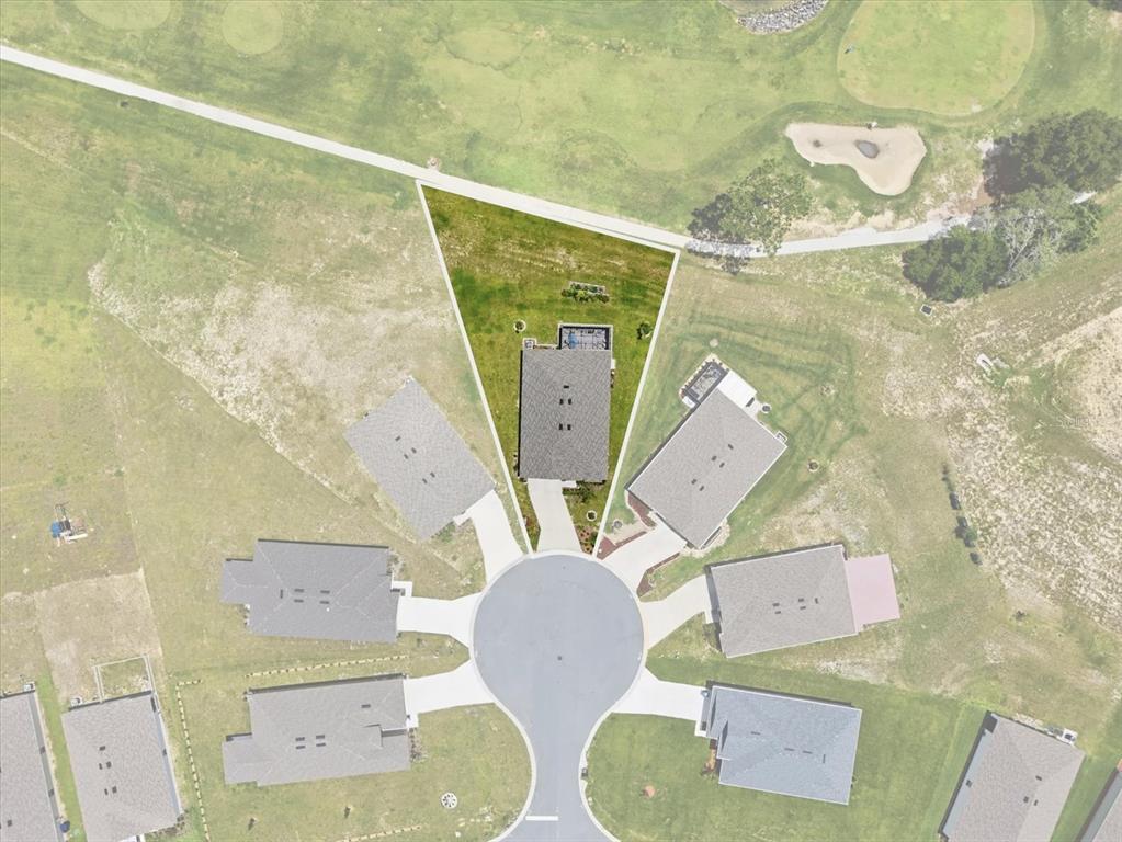 This aerial view shows a house on a pie-shaped lot in a cul-de-sac — 410 W PUTTING GREEN COURT, BEVERLY HILLS, FL