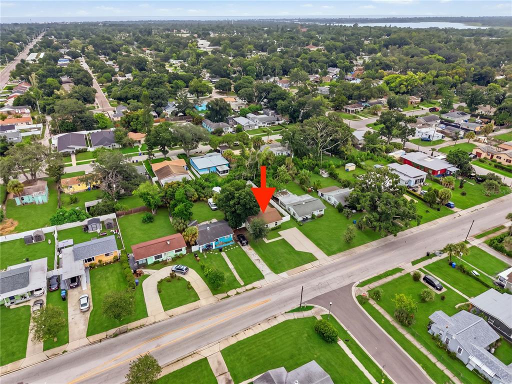 An aerial view shows a single-story house with a brown roof and a large yard — 1542 28TH STREET S, ST PETERSBURG, FL