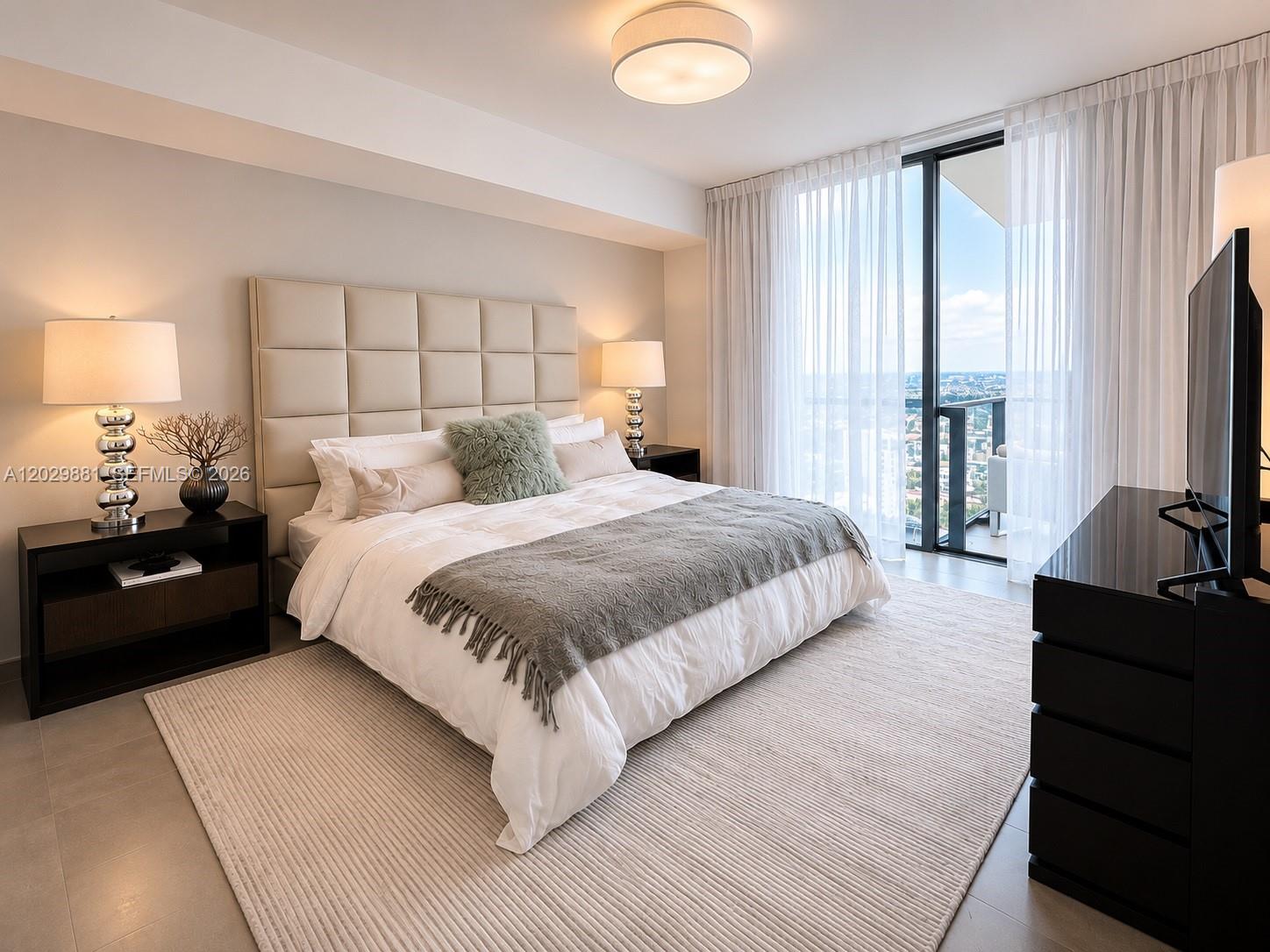 A modern bedroom features a tufted headboard, a gray throw blanket, and floor-to-ceiling windows — 88 SW 7 # 3506, Miami FL 33130, MIAMI, FL