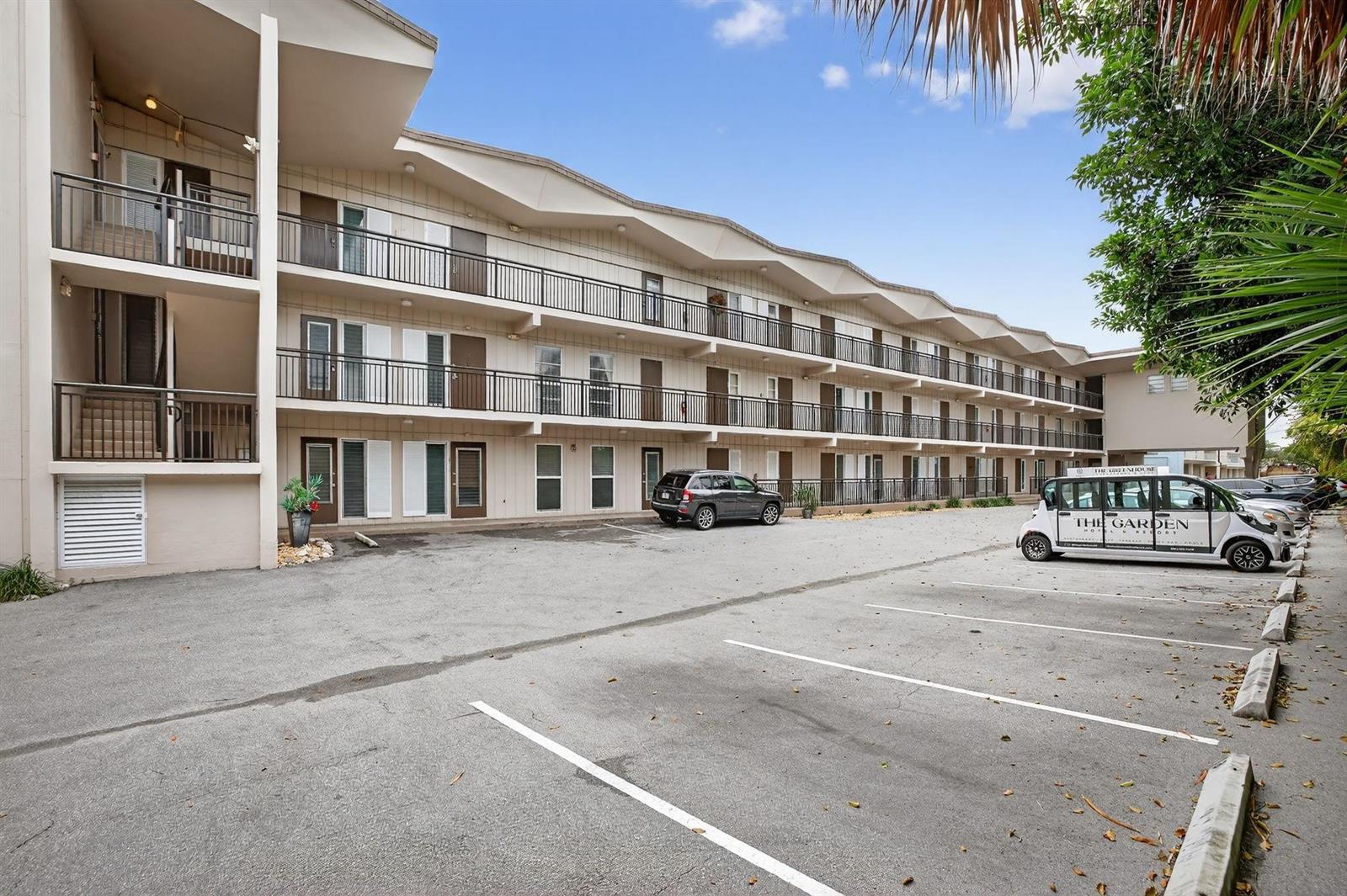 A three-story motel building with exterior balconies and a parking lot in front — 1967 S Ocean Boulevard # 103, Pompano Beach FL 33062, POMPANO BEACH, FL