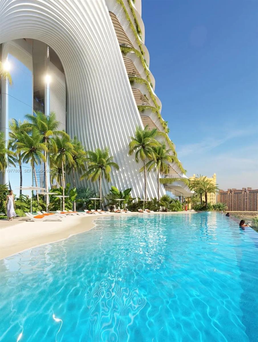 This architectural rendering shows a modern building with a curved facade overlooking a swimming pool — PJCRC17 Ittihad Rd # 0, Dubai, FL