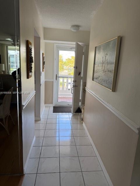 A tiled entryway leads to an open door revealing a balcony with a view — 324 SE 10th St # 207, Dania Beach FL 33004, DANIA BEACH, FL