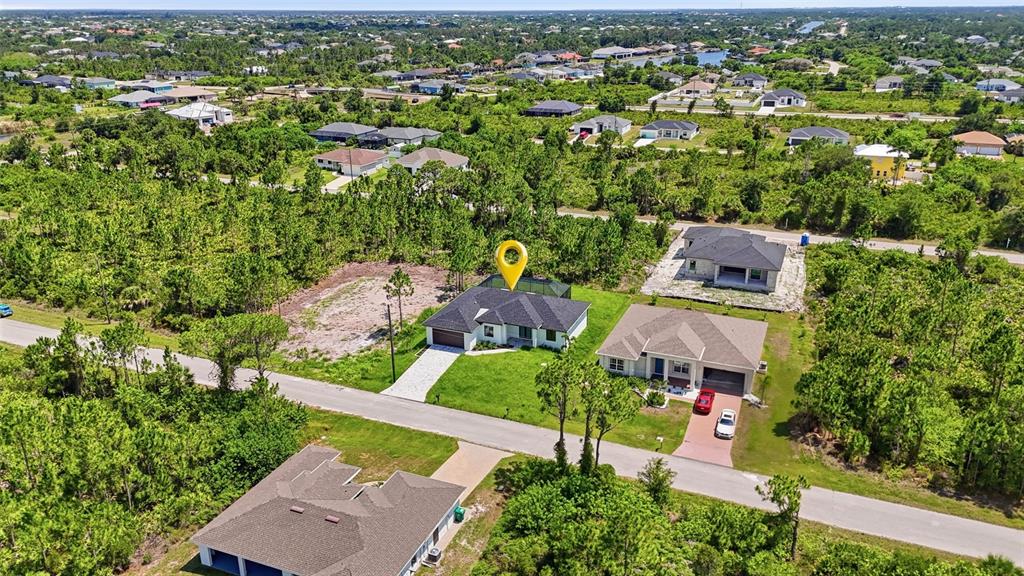 An aerial view shows a single-family home with a yellow location pin in a neighborhood — 14041 NEWSON LANE, PORT CHARLOTTE, FL