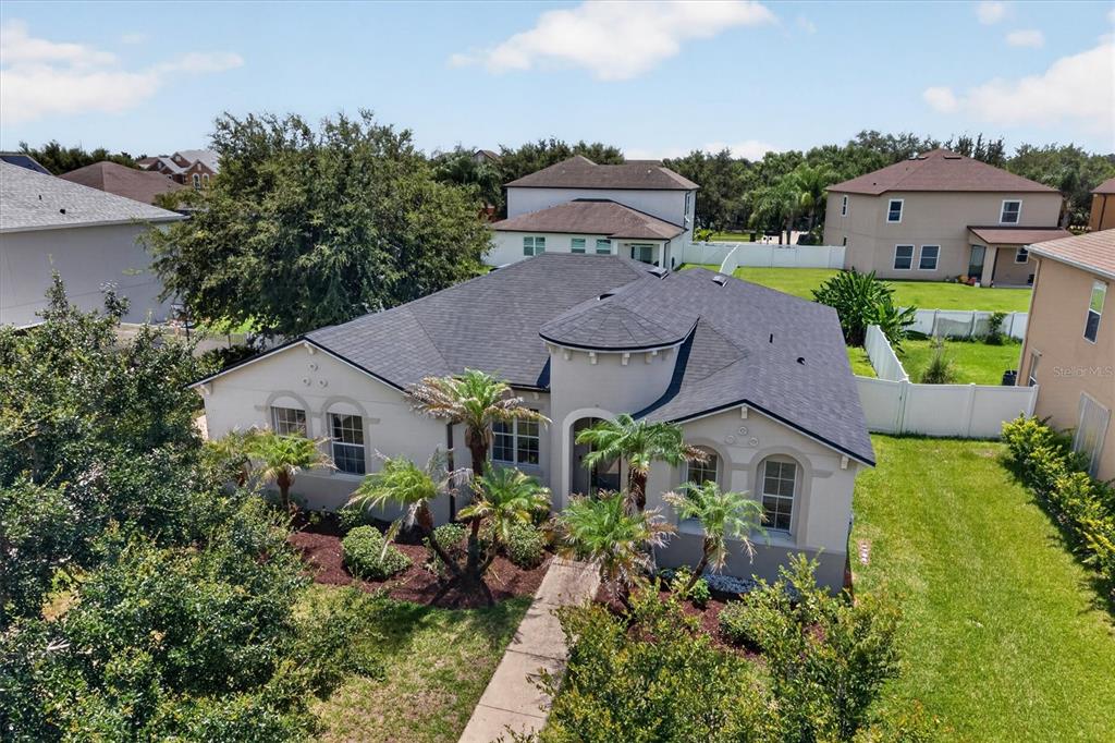 An aerial view of a single-story suburban house with a dark shingled roof and landscaping — 3922 CEDAR HAMMOCK TRAIL, ST CLOUD, FL