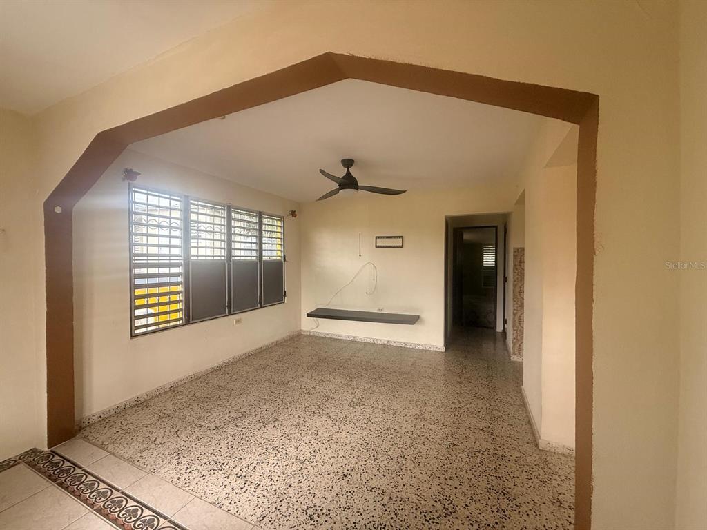An interior room with a ceiling fan, tiled floors, and a large window — Carr. 411, Km. 0.2 LOS POZOS, SECTOR CALVACHE, RINCON, PR