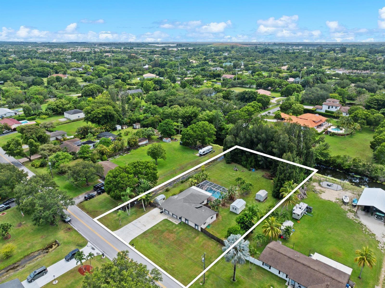 An aerial view shows a single-story house with a pool and sheds on a large lot — 5191 SW 188th Avenue, Southwest Ranches FL 33332, SOUTHWEST RANCHES, FL
